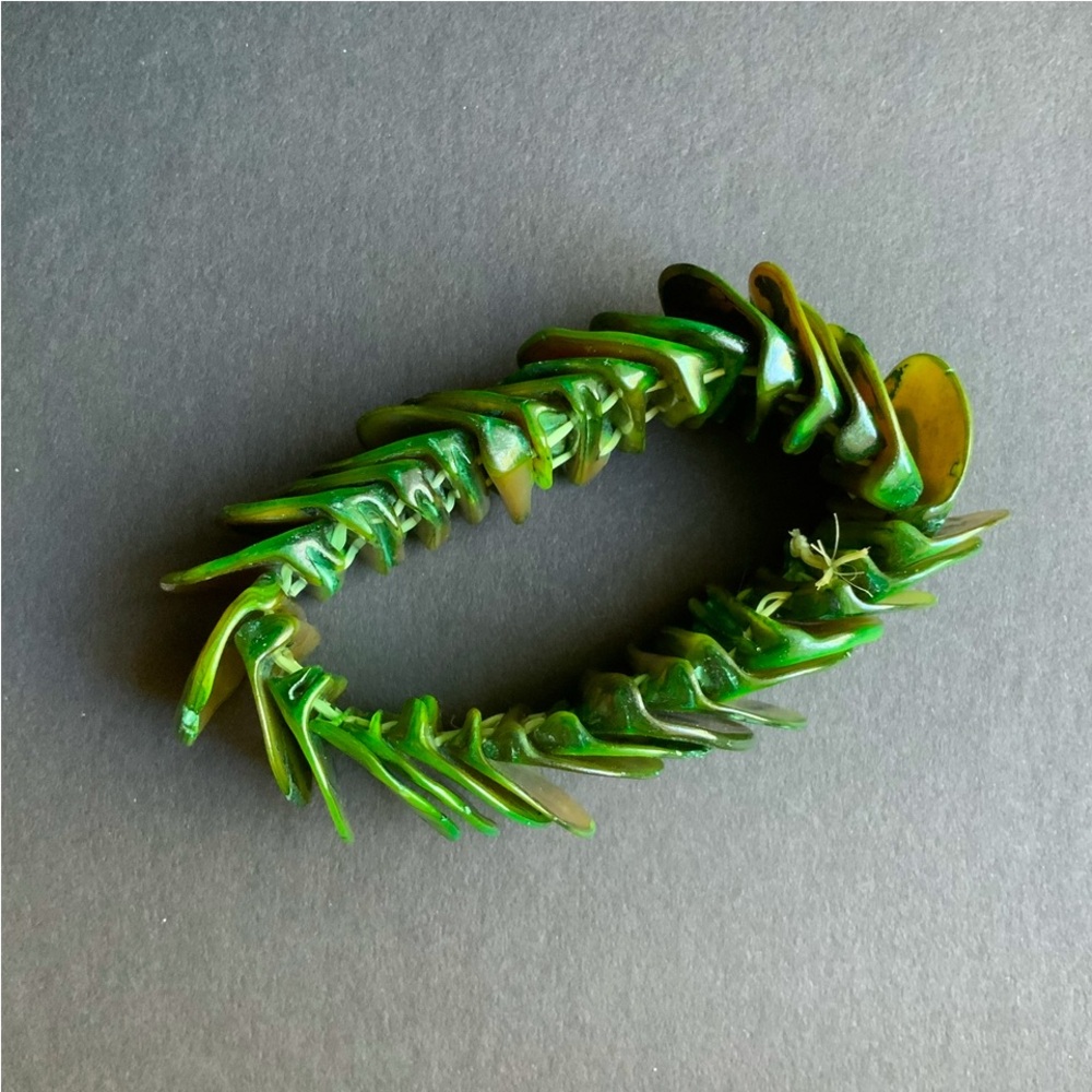 Green seashell-like bracelet.  Looks & feels like seashell material.